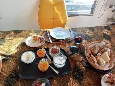 a table with a tray of breakfast food on it at Loc de cabines sur Yacht in Gruissan