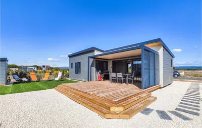 a small house with a deck and a patio at Gorgeous Home In Olonzac With Kitchen in Olonzac