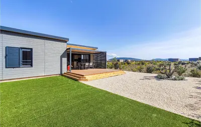 a house with a backyard with a lawn at Gorgeous Home In Olonzac With Kitchen in Olonzac