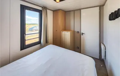 a bedroom with a white bed and a window at Gorgeous Home In Olonzac With Kitchen in Olonzac