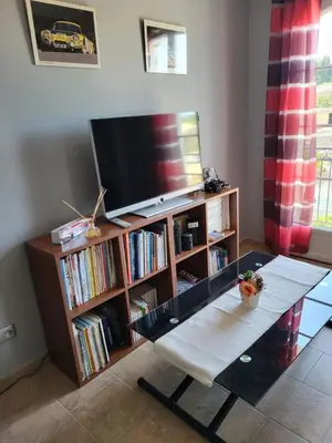 a living room with a tv and a coffee table at La Bastide du Canal avec piscine et clim in Carcassonne