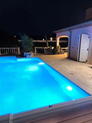 a swimming pool at night with a house at La Bastide du Canal avec piscine et clim in Carcassonne