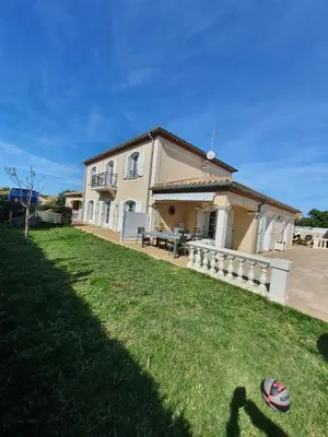 a house with a lawn in front of it at La Bastide du Canal avec piscine et clim in Carcassonne