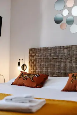 a bed with two pillows on top of it at Studio avec parking vue sur la Cité de Carcassonne in Carcassonne