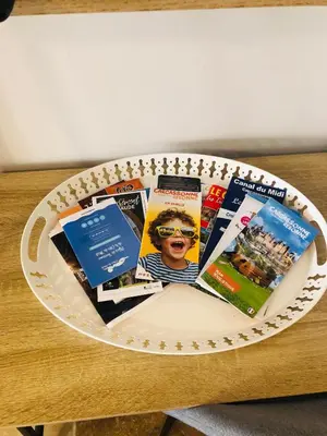 a plate with a bunch of magazines on a table at Studio avec parking vue sur la Cité de Carcassonne in Carcassonne