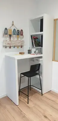 a white desk with a black chair in a room at L'Annexe in Sigean