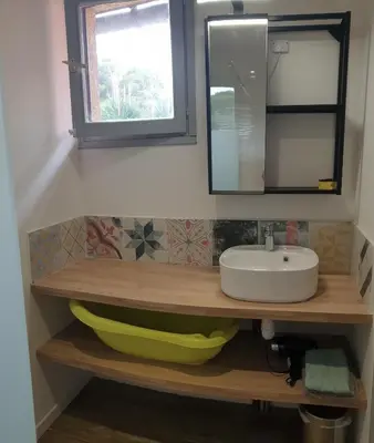 a bathroom with a sink and a mirror at L'Annexe in Sigean