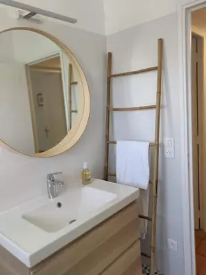 a bathroom with a sink and a mirror at La Maison de Colette - Coeur de village in Cuxac-dʼAude