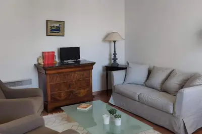 a living room with a couch and a table at La Maison de Colette - Coeur de village in Cuxac-dʼAude