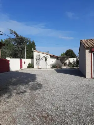 a driveway in front of a white building at Tranquillité B&B in Cuxac-dʼAude