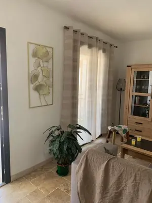 a living room with a couch and a plant at Villa 18 in Narbonne