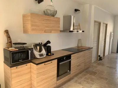 a kitchen with a counter with a microwave and a stove at Villa 18 in Narbonne