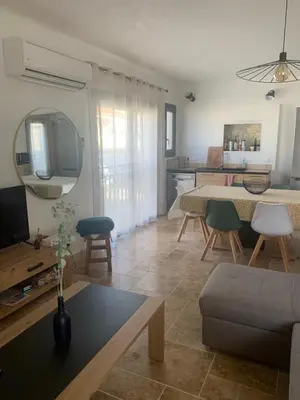 a living room with a couch and a dining room at Villa 18 in Narbonne