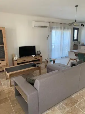 a living room with a couch and a tv at Villa 18 in Narbonne