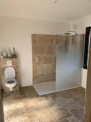 a bathroom with a toilet and a glass shower at Villa 18 in Narbonne