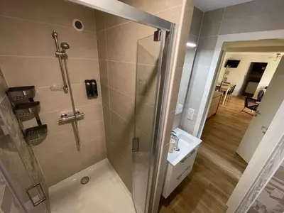 a shower with a glass door in a bathroom at Au point du jour - Gîtes Carcassonne, Lac de la Cavayère in Carcassonne