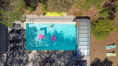 an overhead view of a swimming pool with a pink ball at Au point du jour - Gîtes Carcassonne, Lac de la Cavayère in Carcassonne