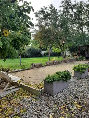 a park with a bench and some plants at Tranquillité Gite in Cuxac-dʼAude