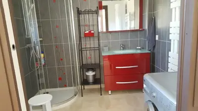 a bathroom with a red sink and a tub at Tranquillité Gite in Cuxac-dʼAude