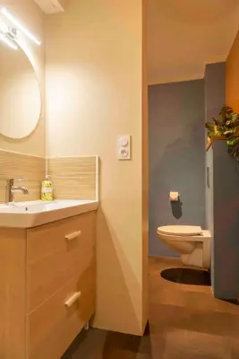 a bathroom with a sink and a toilet at Autour d'une Toile in Rouvenac