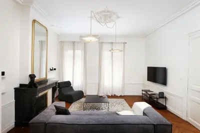 a living room with a couch and a tv at La Pittoresque 1 in Carcassonne