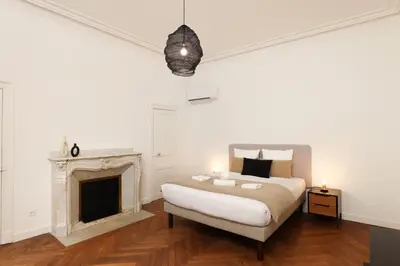 a bedroom with a bed and a fireplace at La Pittoresque 1 in Carcassonne