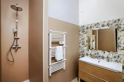 a bathroom with a sink and a mirror at La Pittoresque 1 in Carcassonne