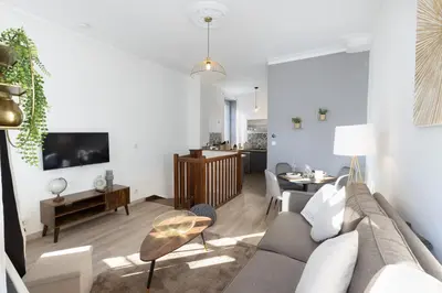 a living room with a couch and a table at N1 Des Études Cosy Duplex Netflix Balcon ConciergerieDameCarcas in Carcassonne