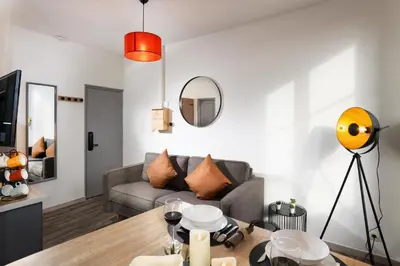 a living room with a couch and a table at N2 des Études Cosy Hypercentre Wifi ConciergerieDameCarcas in Carcassonne