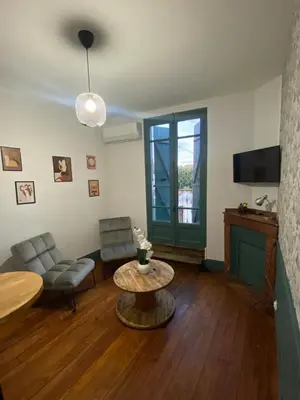 a living room with a coffee table and a couch at Appart 55 in Mazamet