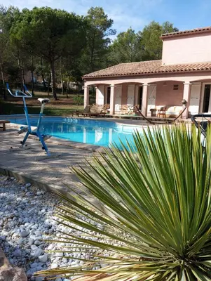 a swimming pool in front of a house at Le Mas Victoria - Chambres d'hôtes avec table d'hôtes-Parking privé ferme in Carcassonne