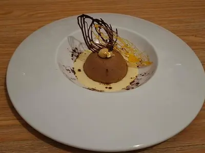 a white plate with a chocolate dessert on it at Le Mas Victoria - Chambres d'hôtes avec table d'hôtes-Parking privé ferme in Carcassonne