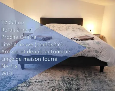 a bedroom with a bed with a blue comforter at T2 Duplex Pamiers Plein Centre - Logement entier - Nouveau in Pamiers