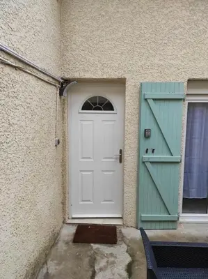 a white door and a window and a building at T2 Duplex Pamiers Plein Centre - Logement entier - Nouveau in Pamiers