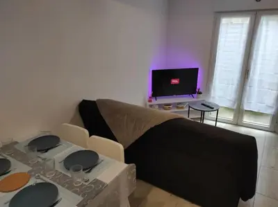 a living room with a couch and a table at T2 Duplex Pamiers Plein Centre - Logement entier - Nouveau in Pamiers