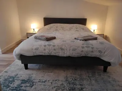 a bedroom with a bed with two towels on it at T2 Duplex Pamiers Plein Centre - Logement entier - Nouveau in Pamiers