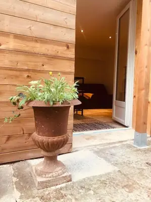 a plant in a pot in front of a building at Bienvenue « À l’ombre du figuier » in Pieusse