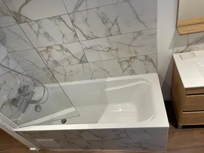 a bathroom with a white tub and a sink at Les Appartements du Cep’t in Mazamet