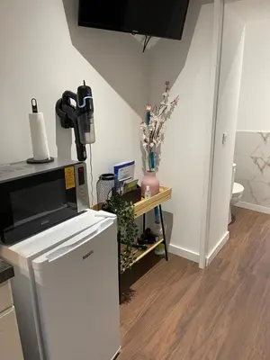 a kitchen with a counter with a microwave and a table at Les Appartements du Cep’t in Mazamet