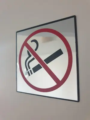 a sign with a no smoking sign on a wall at La Robine in Narbonne