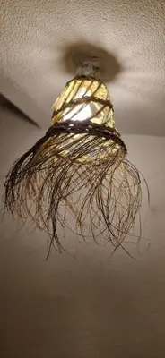 a light hanging from the ceiling of a room at La Robine in Narbonne