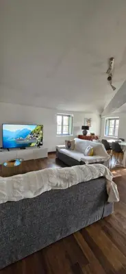 a large bedroom with two beds and a flat screen tv at La Robine in Narbonne