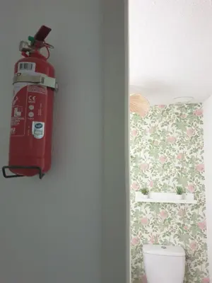 a fire hydrant sitting on a wall next to a toilet at La Robine in Narbonne