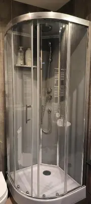 a shower with a glass enclosure in a bathroom at Appartement sous les remparts in Carcassonne