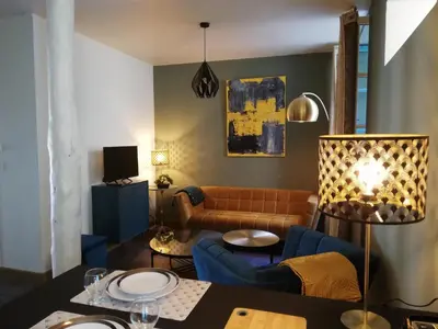 a living room with a couch and a table at Appartement sous les remparts in Carcassonne