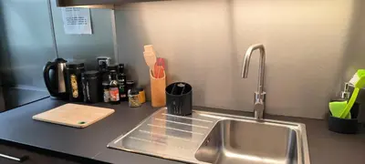 a kitchen counter with a stainless steel sink and a knife block at Appartement sous les remparts in Carcassonne