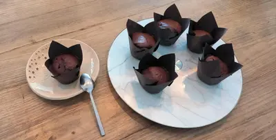 a white plate with chocolate cupcakes in bats at Appartement sous les remparts in Carcassonne
