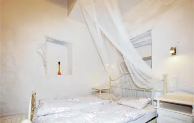 a white bedroom with a bed and a window at Gorgeous Home In Villeseque Des Corbier in Villesèque-des-Corbières