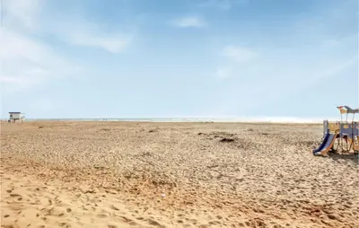 an empty beach with a playground in the sand at Gorgeous Home In Villeseque Des Corbier in Villesèque-des-Corbières