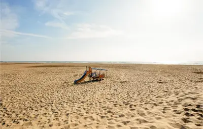 a beach with a slide on the sand at Gorgeous Home In Villeseque Des Corbier in Villesèque-des-Corbières